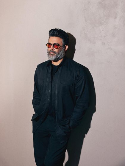 The play of light and shadow in this shot adds to the dark and mysterious mood of the outfit.