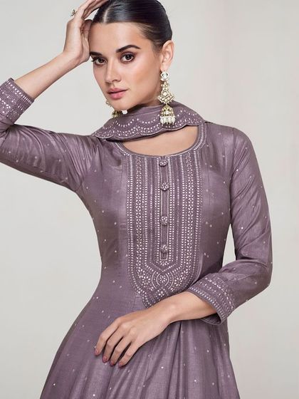 This dusty purple premium silk gown is modern and chic. The unique neckline and subtle sequin work make it a sophisticated choice for any formal event.