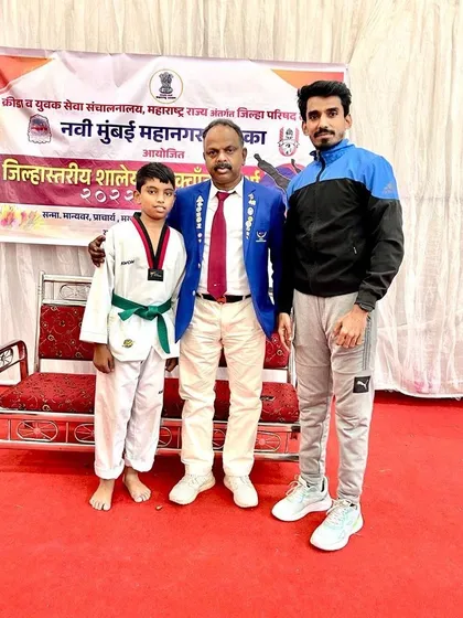 Standing with one of my students and an official at the district-level school games.