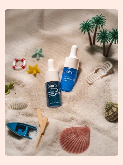 Miniature beach-themed props create a playful scene for these face serum bottles. This kind of creative and whimsical product photography is great for engaging social media content.