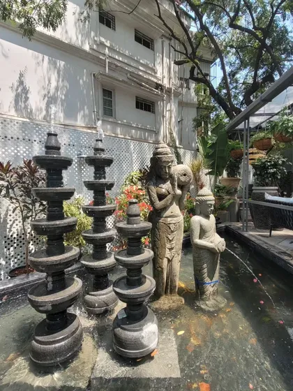 Water is a key sensory element in the design. This feature combines traditional stone sculptures with the gentle sound of flowing water, creating a tranquil focal point within the bustling retail environment.