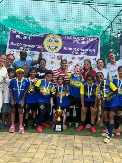 The whole family comes out to support. Our U12 girls celebrating their win with coaches and parents.