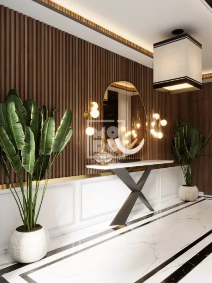 An entryway sets the tone for the entire home. For this lobby, we combined warm wood panelling, striking marble floors, and sculptural lighting to create a grand and welcoming first impression that speaks of modern elegance.
