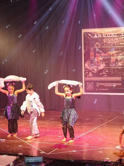 The kids use fabric props in a creative way during their charming stage performance.