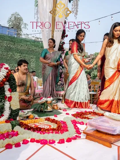 A sacred moment as the bride and her family perform wedding rituals. The decor is centered around a beautiful floral deity, creating a divine atmosphere for the ceremony.