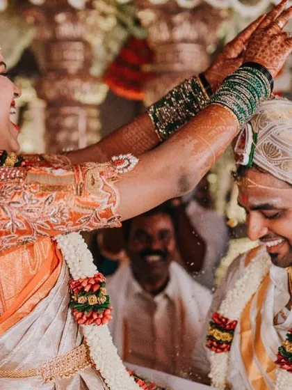 This is what it's all about. Pure, uninhibited joy. I love creating outfits for fun-loving brides who embrace every moment of their wedding day. This candid shot captures the spirit of a beautiful South Indian wedding ceremony.