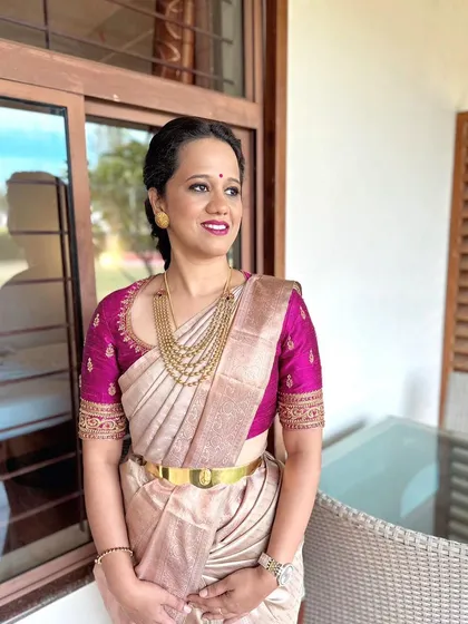 The details make the design. This is a close-up of a hand-worked raw silk blouse in a rich magenta, featuring delicate embroidery around the neckline and sleeves. It’s a versatile piece designed to elevate any silk saree.