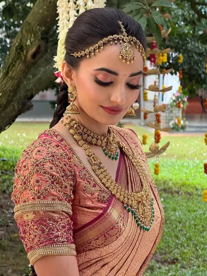 A close-up of the bride in an outdoor setting. The makeup is designed to look stunning in natural light, with a focus on glowing skin.