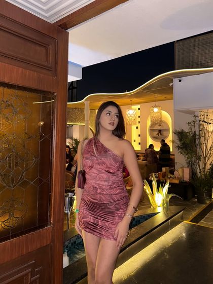 A full shot of the mini dress, showing off the ruched detailing.