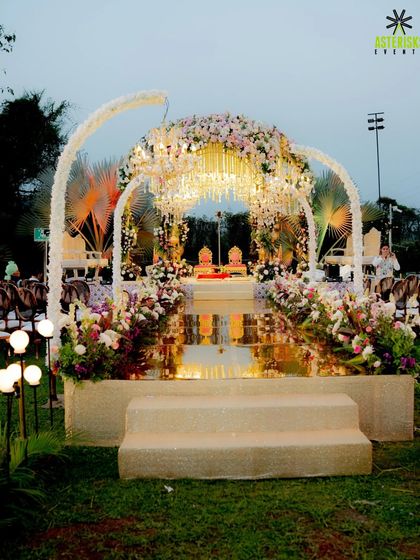 An ethereal mandap setup on a floating stage over the water, combining modern architecture with classic floral design for a truly unique wedding ceremony.