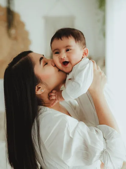 A mother's kiss and a baby's giggle. We focus on these sweet, simple interactions to create emotionally rich portraits during our family sessions.
