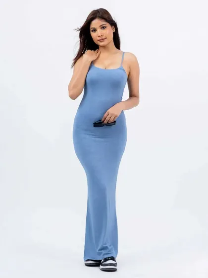 A model in a blue version of the dress, showing the product in different colorways. The slight movement in her hair adds a touch of life to the clean studio shot.