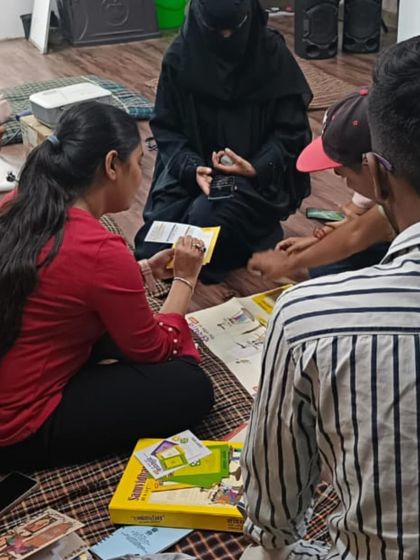 A group of participants works together on a task, using cards and books to learn about fundamental rights. These hands-on activities make abstract concepts tangible.