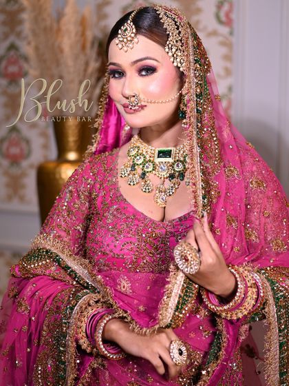 The complete look for a Muslim bride, featuring a bright pink outfit and heavy kundan jewelry. The makeup is glamorous yet elegant, designed to make the bride feel confident and beautiful.