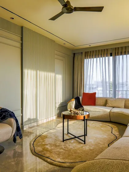 The fluted wall panels and soft curtains in this living room add texture and softness. Every detail is intentional, echoing the client’s desire for a space that feels open, grounded, and truly lived-in.