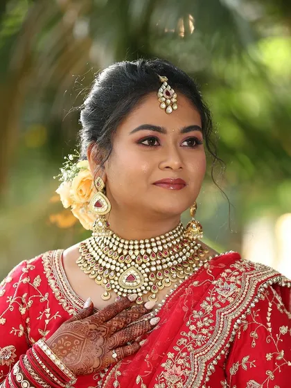A close-up portrait of Akanksha. This shot highlights the detailed eye makeup and the radiant finish on her skin, perfect for her reception.