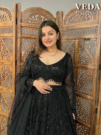 A smiling shot in this classic black lehenga. It's a versatile piece that guarantees you'll be the star of the party.