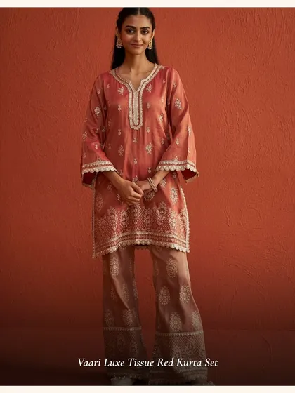 The Vaari Luxe Tissue Red Kurta Set is a beautiful muted red, perfect for those who want a sophisticated festive look. The tissue fabric gives it a lovely sheen.