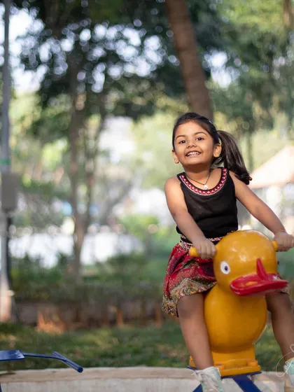 A happy moment on a spring rider at the park. Her fourth birthday shoot was all about capturing her in her element, playing and having fun.