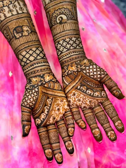 A close-up of a bridal design featuring elephants and other traditional motifs. The fine detailing and rich henna application are hallmarks of my bridal work.