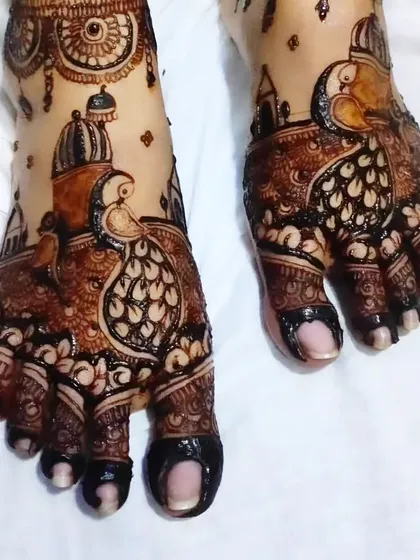 Another angle of the peacock feet design, showing how the pattern covers the entire foot for a grand bridal look.