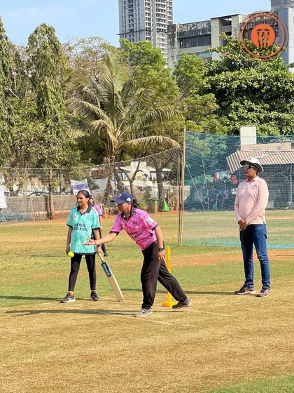 Two women cricketers, a bowler and a non-striker, during a break in play at the PPL.
