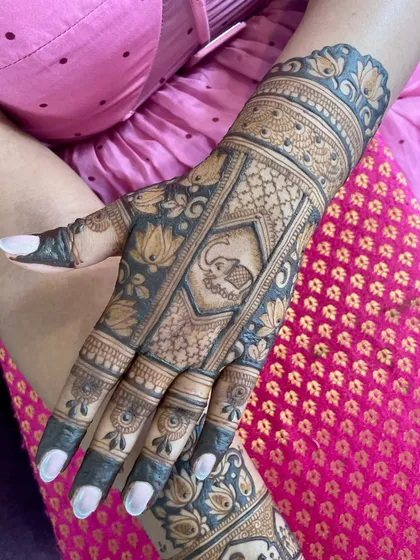 A lovely design featuring a baby elephant motif. The surrounding patterns are a mix of floral and geometric elements.