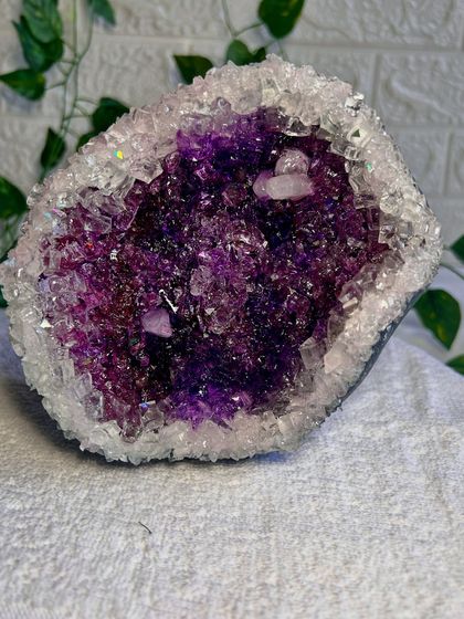 A full view of the handmade Amethyst geode. The rich purples and shimmering crystals make it a true statement piece for any space.