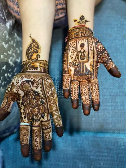 A complete view of a Teej-themed mehndi. One hand features a detailed peacock, while the other portrays a woman on a swing, capturing the joyful spirit of the festival.