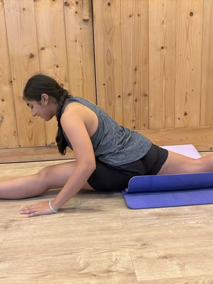 Using a rolled-up mat for support is a great way to modify the splits. We teach you how to work with your body.