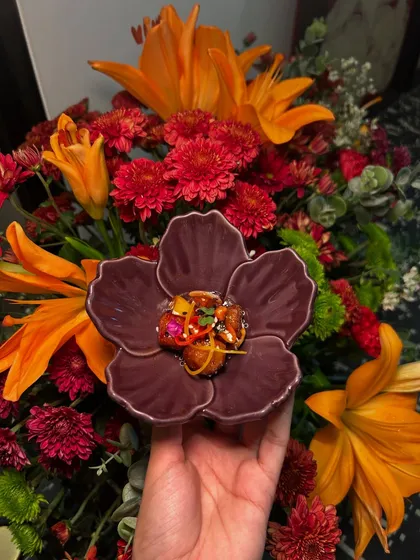 Another beautiful appetizer, this time a piece of crispy chilli chicken, served in a purple flower bowl.