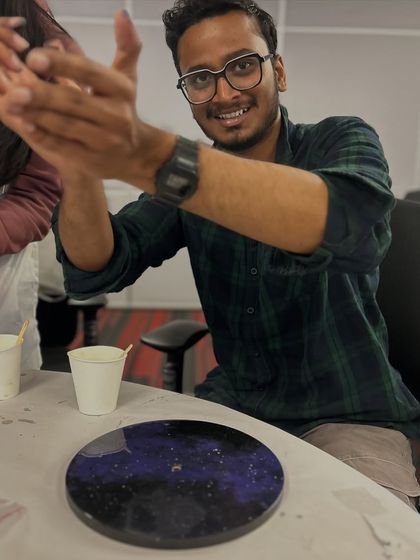 A member of the NetApp team excited about his finished resin clock. Our corporate workshops are designed to ensure everyone leaves with a sense of accomplishment and a cool piece of art.