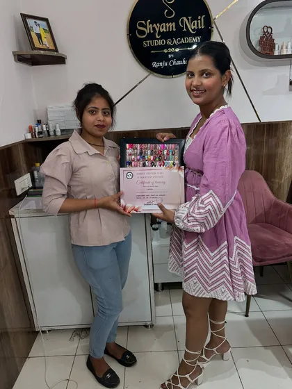 Handing out another certificate to a happy student. She is now a certified nail artist, ready for clients.