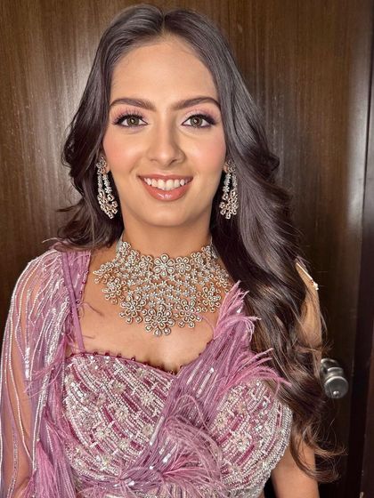 A beautiful portrait showing her radiant smile. The makeup is glamorous yet feels light and comfortable for a long night of celebrating.
