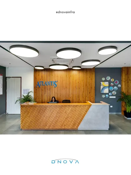 The reception area for Atlantis in Noida sets a professional and welcoming tone. My general contracting team ensured a flawless execution of the design, from the slatted wood paneling and geometric desk to the integrated halo lighting, creating a strong first impression.