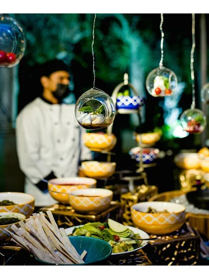 Another view of our interactive Burrata Bar, showing the array of fresh toppings and dressings available. The hanging ingredients in glass orbs add a touch of whimsy and elegance.