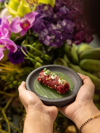 A beautifully presented beetroot kebab on a banana leaf, showcasing the artistic plating and unique flavors of our 'RUMI' Diwali menu.