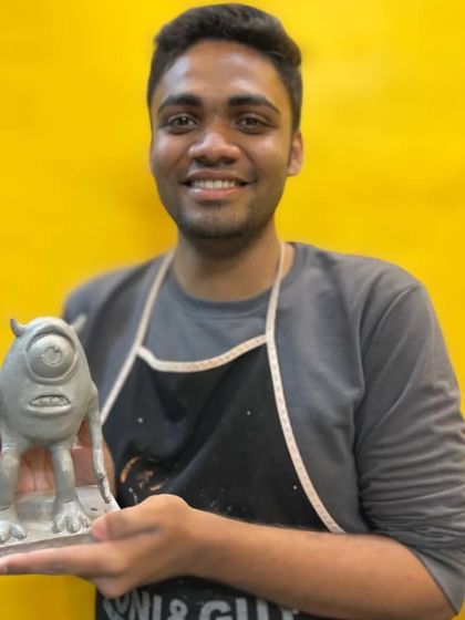 Student Raheel proudly presents his finished clay sculpture of Mike Wazowski. Our classes guide you through the process of transforming a simple lump of clay into a detailed and expressive character.