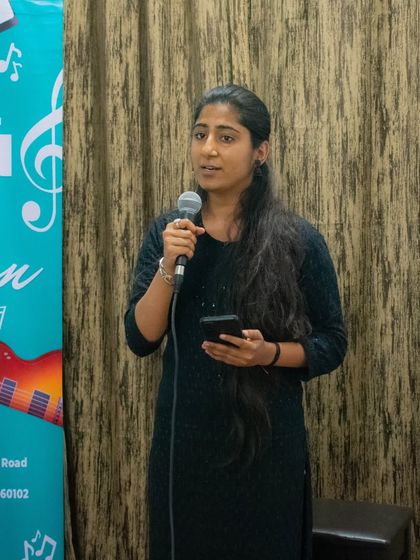 A student sharing her performance at the HSR branch open mic. These events are a great way for students to connect with each other.