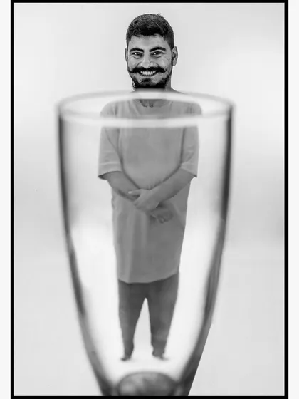 A playful and creative portrait using the distortion of a glass to create a unique perspective. This demonstrates my interest in experimenting with practical effects to produce imaginative and memorable images.