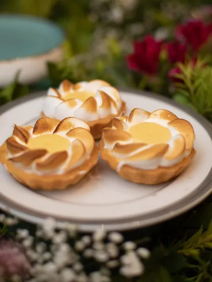 Delicate lemon meringue tarts, perfectly browned and ready to be served. Our pastry chefs excel at creating classic desserts with precision and flair.