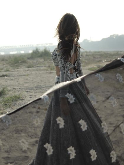 A final, ethereal shot of this incredible lehenga, with the dupatta flowing in the wind.