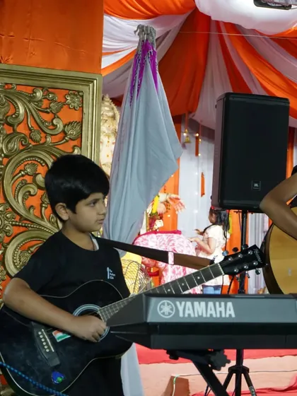 A young performer focused on his craft, playing both guitar and keyboard during our Ganesh Chaturthi event. We nurture multi-talented musicians.