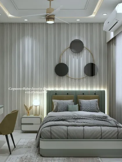 The bed is set against a wall with striped wallpaper and a modern, circular art piece. The design is simple, yet the combination of patterns and textures makes it visually interesting.