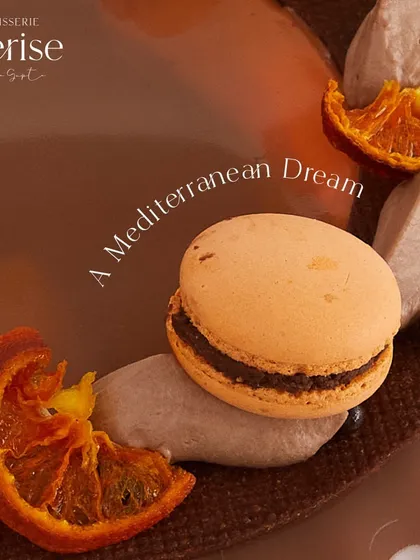 A Mediterranean dream. This close-up shows the details of the Valencian Sunshine, from the candied orange slices to the orange-flavored macarons.