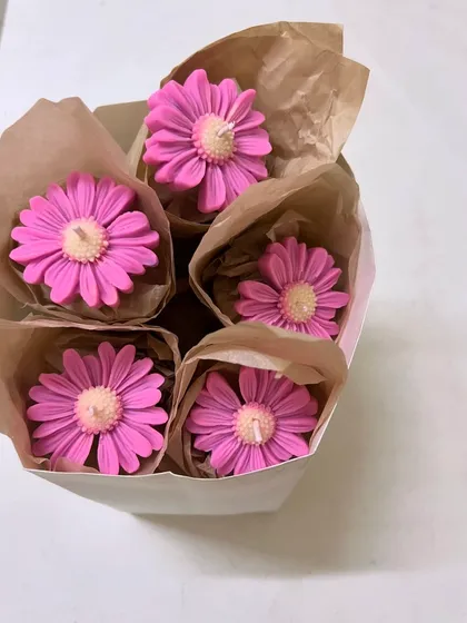 Who doesn't love flowers? These daisy-shaped sculptural candles are a beautiful and unique gift, shown here wrapped like a bouquet.