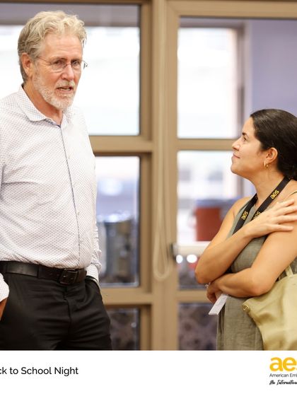 Our director speaks with a parent at Elementary School Back to School Night. Open communication with our families is a top priority.