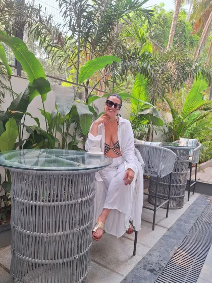 Coffee and I go hand in hand. A white-on-white look with a bikini top, open shirt, and wide-leg pants is a chic and sophisticated choice for a resort breakfast.