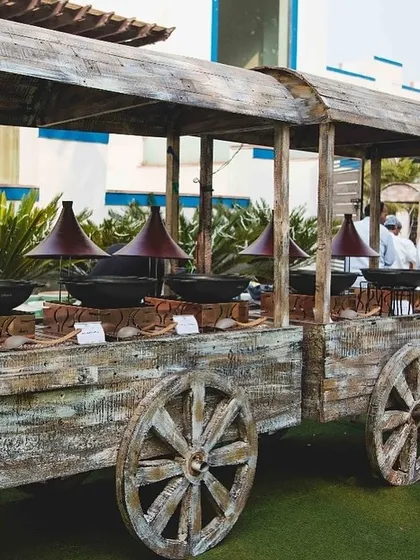 A unique rustic wooden cart designed to serve as a live station or a buffet counter for themed events.