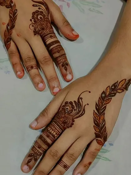 A simple yet striking design focusing on a single finger and a delicate vine.